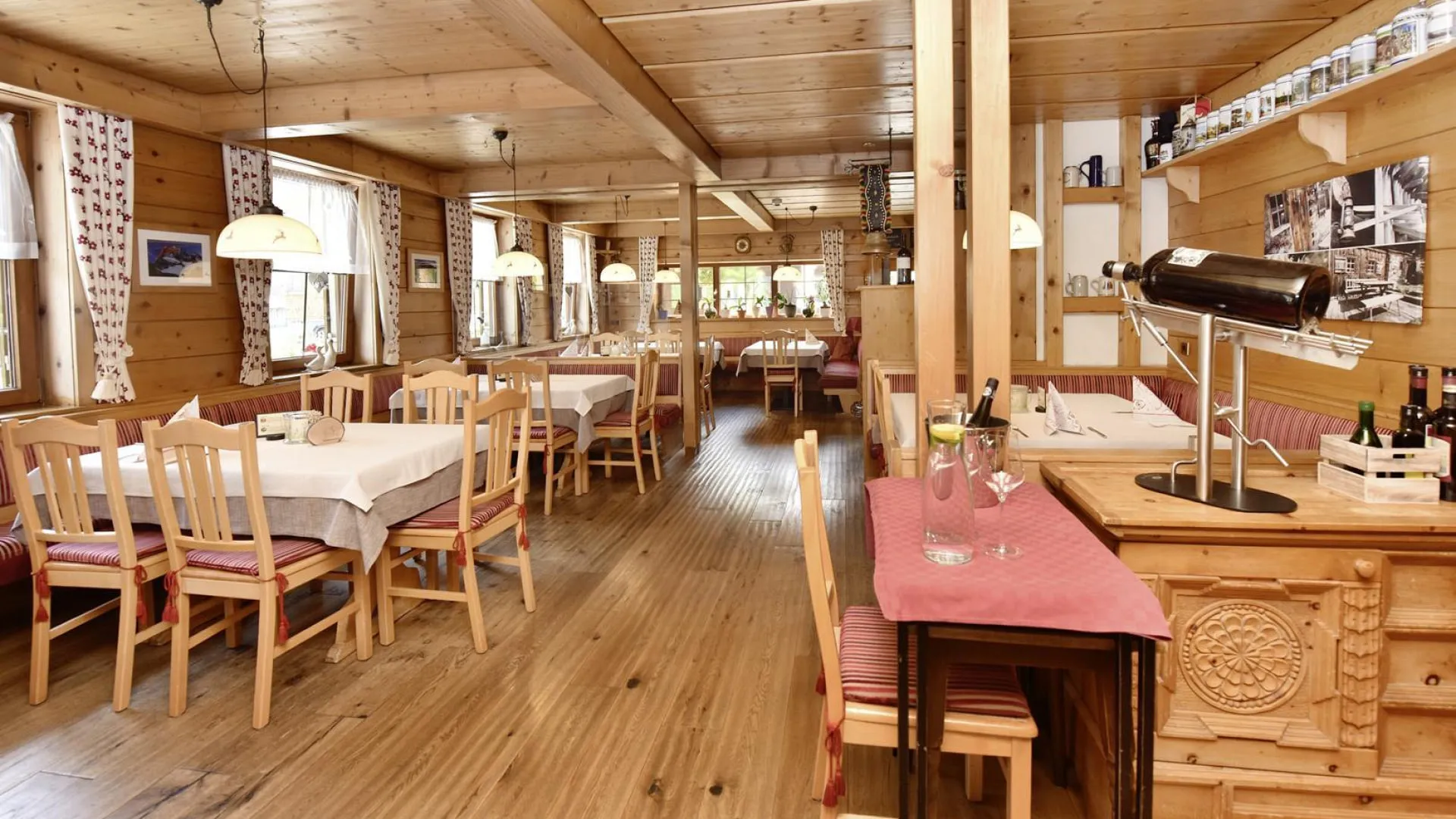 interior of a cozy restaurant with wooden decor and tables