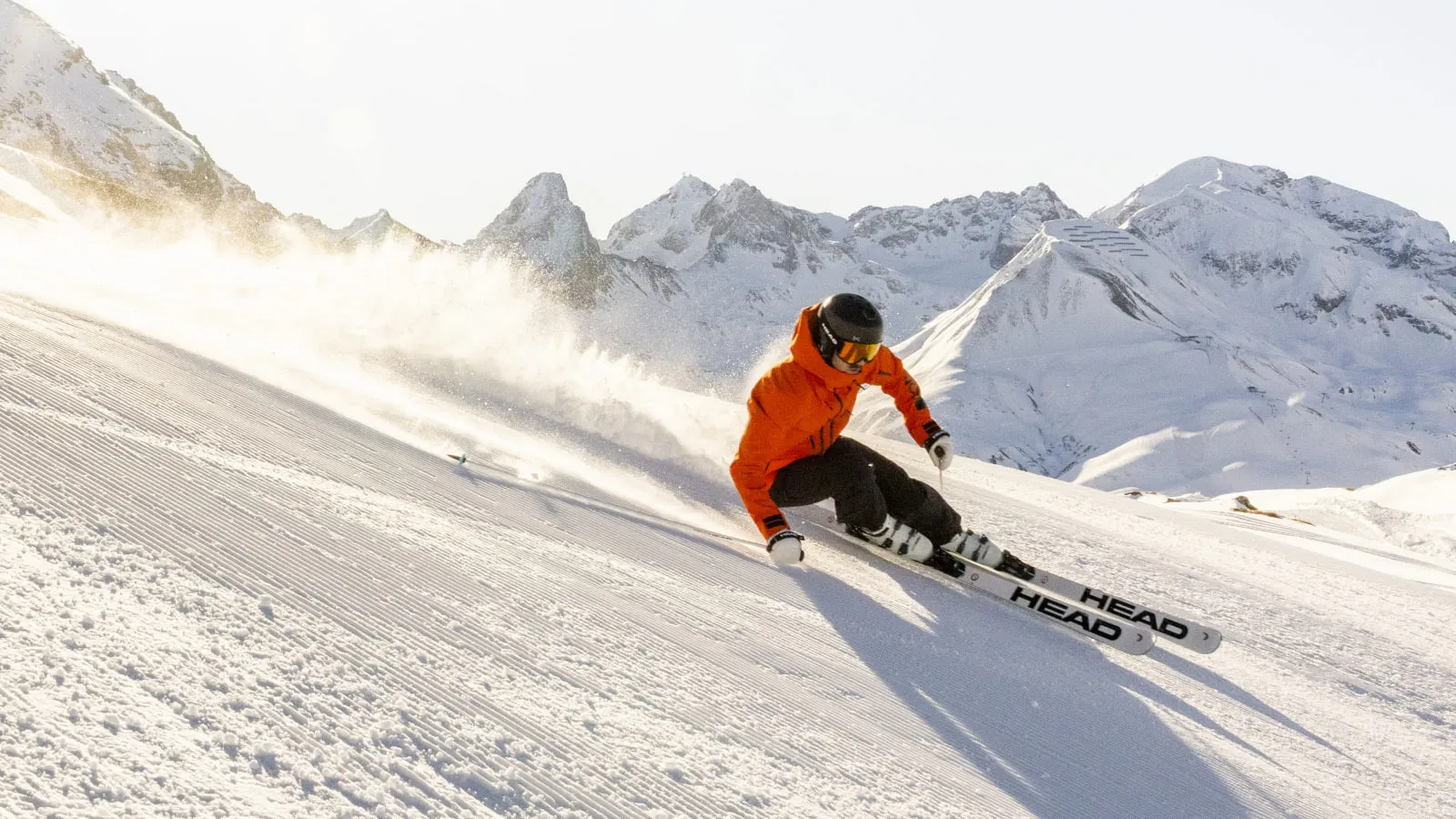 Skier in orange outfit on a slope in Lech Zürs